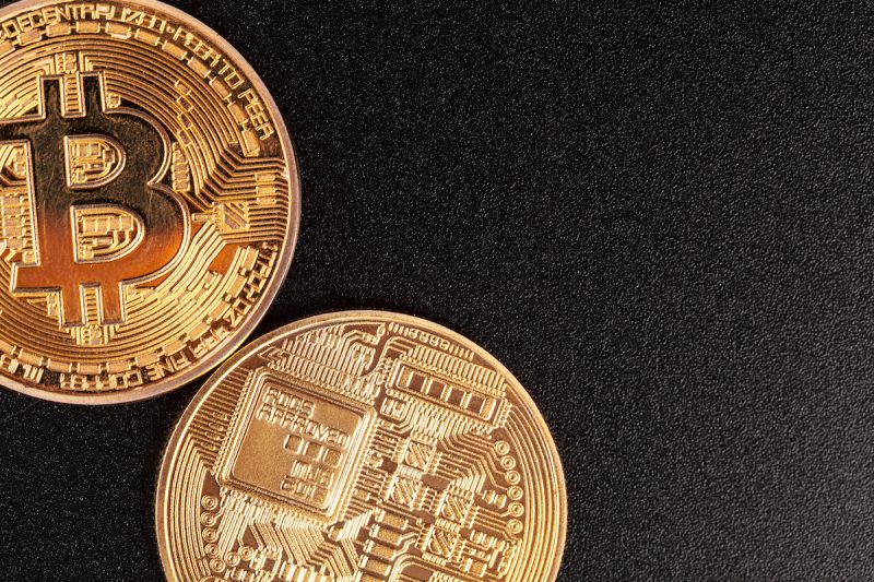 golden-bitcoins-on-black-background-trading-conce-2022-02-16-06-56-36-utc.jpg
